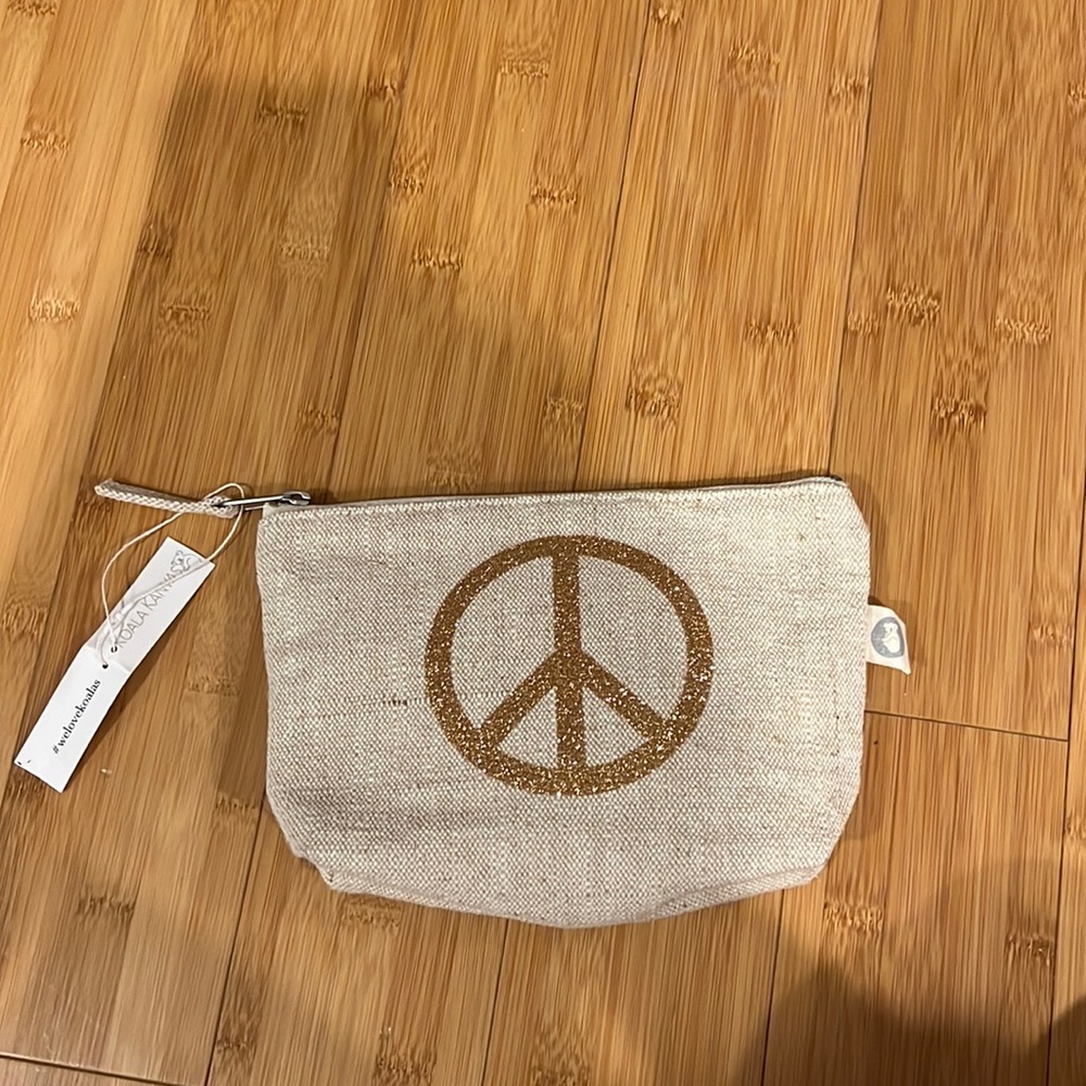 NWT-Koala Kanvas clutch, gold peace sign.